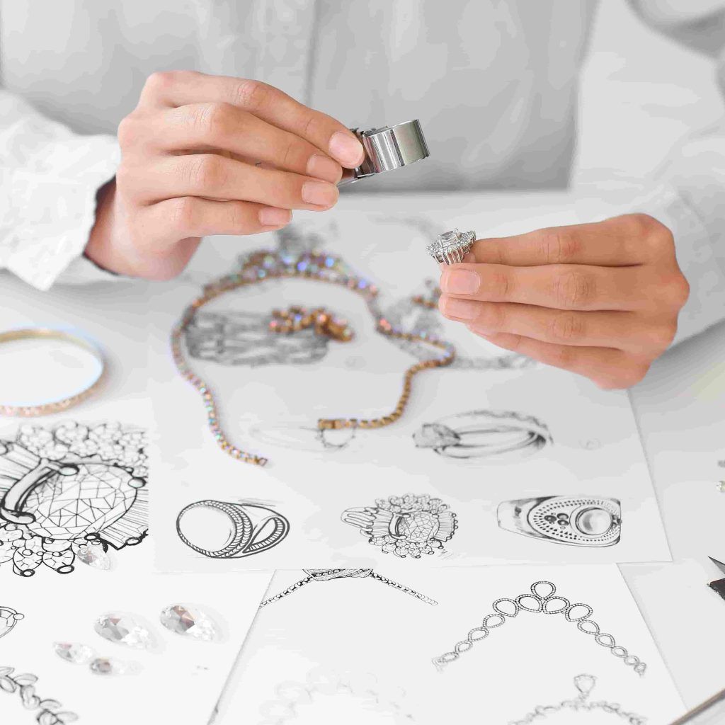 a jeweler inspecting a piece of jewelry under a magnifier