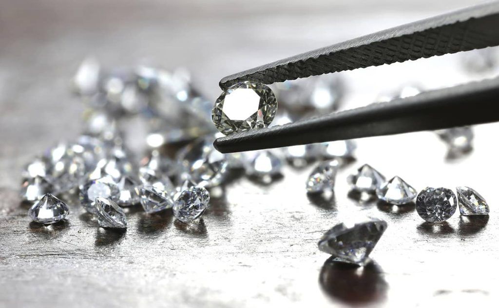 diamond held between tweezers